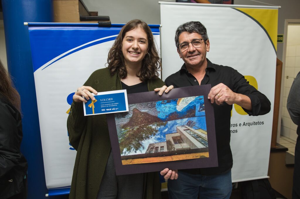 A arquiteta Luiza Tonial da Silveira ganhou o primeiro lugar e recebeu o prêmio das mãos do diretor financeiro do CREA-RS, o engenheiro civil José Luiz Garcias